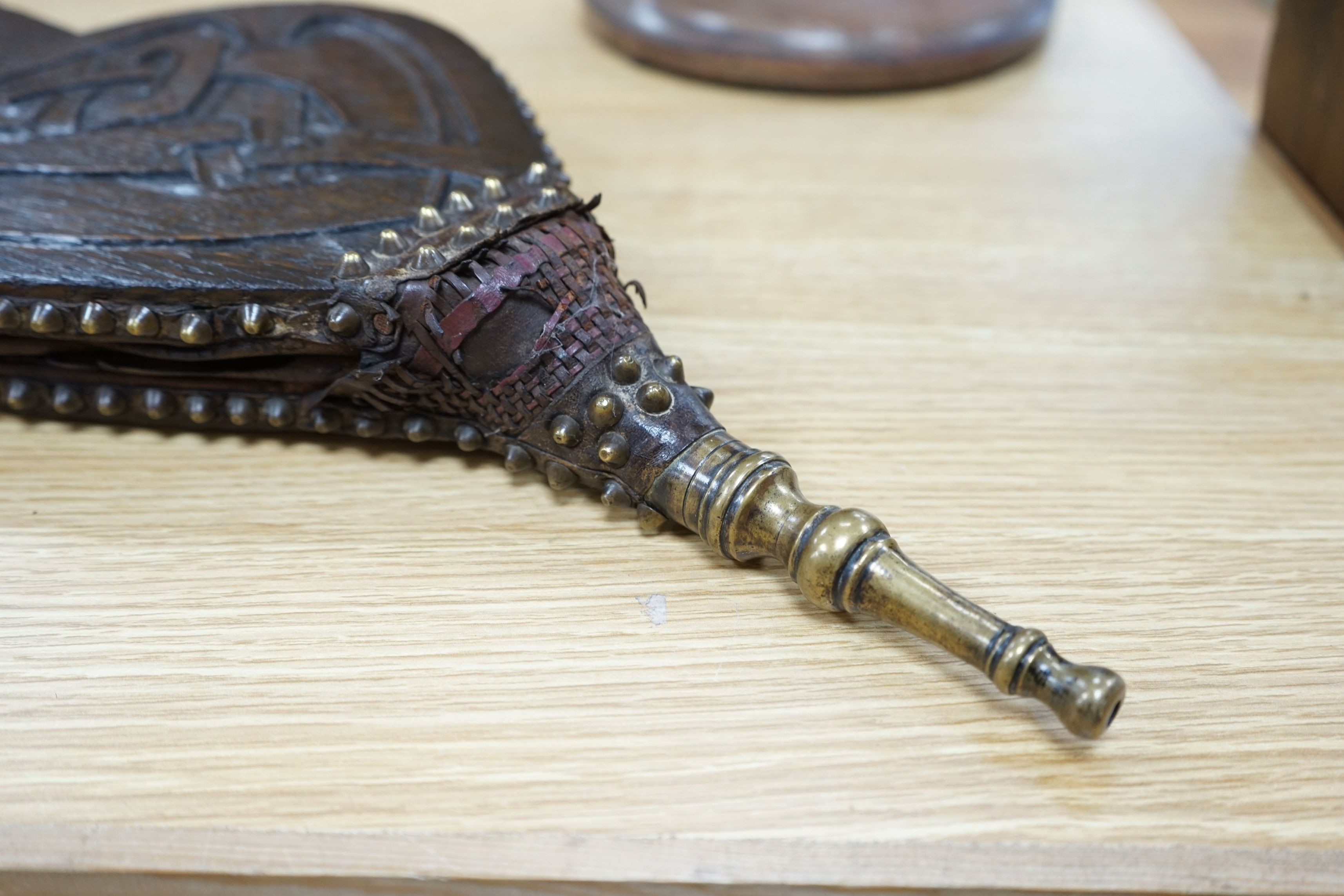 A carved oak Otley bellows, designed by A Knox for Liberty & Co. 75cms high